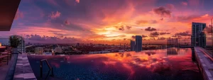 a vibrant sunset casts a warm glow over a stylish miami condo, showcasing a luxurious rooftop pool with panoramic city views, embodying the lifestyle benefits of modern urban living.