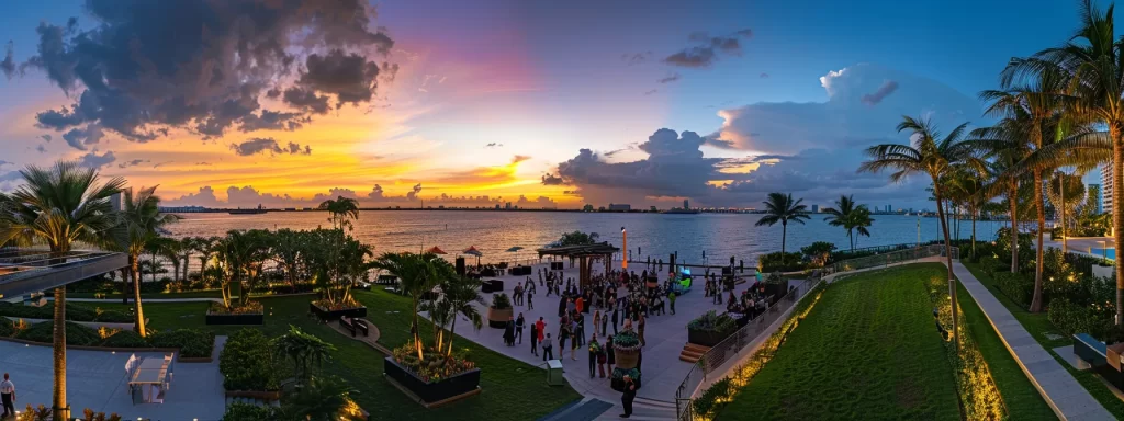 a vibrant waterfront community event at sunset in miami showcases residents mingling and celebrating in elegantly designed outdoor spaces, surrounded by lush greenery and the shimmering waters of the bay.